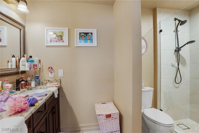 bathroom featuring toilet, a shower stall, and vanity