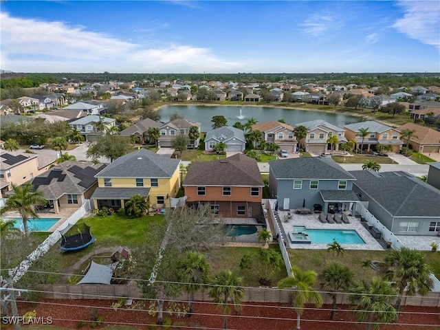 bird's eye view featuring a water view and a residential view