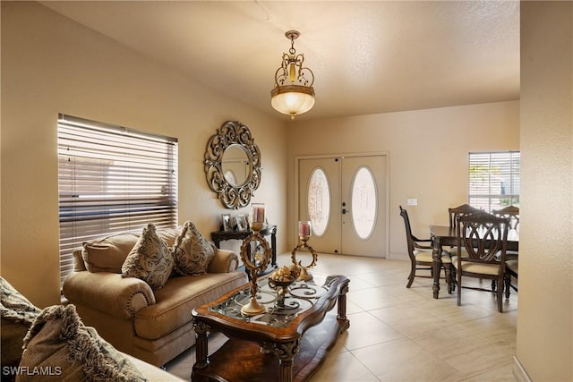 living area with light tile patterned flooring and french doors