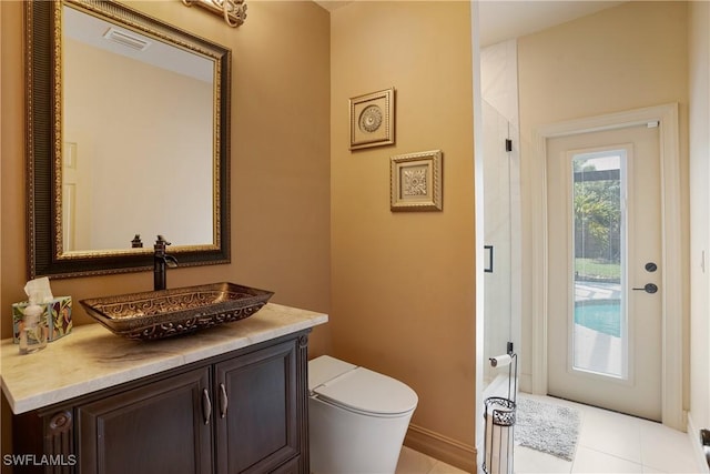 bathroom featuring toilet, tile patterned floors, visible vents, and vanity