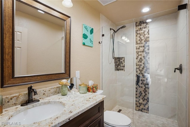 full bath with toilet, recessed lighting, visible vents, vanity, and a stall shower