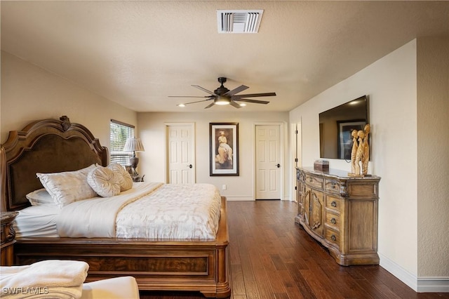 bedroom with dark wood-style floors, baseboards, visible vents, and a ceiling fan