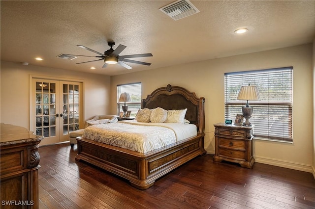 bedroom with visible vents, dark wood-style flooring, and french doors