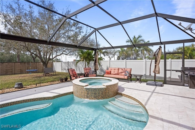 view of swimming pool with glass enclosure, a fenced backyard, an outdoor hot tub, a fenced in pool, and a patio area