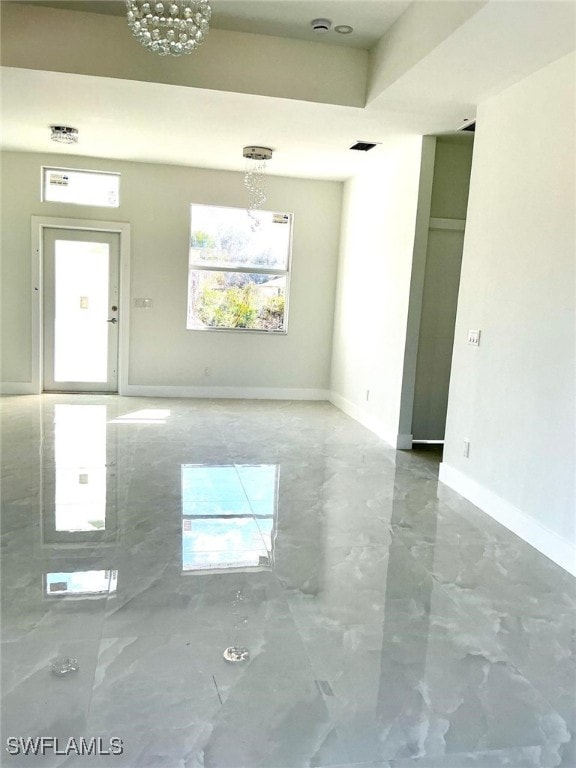 unfurnished room featuring marble finish floor, visible vents, and baseboards