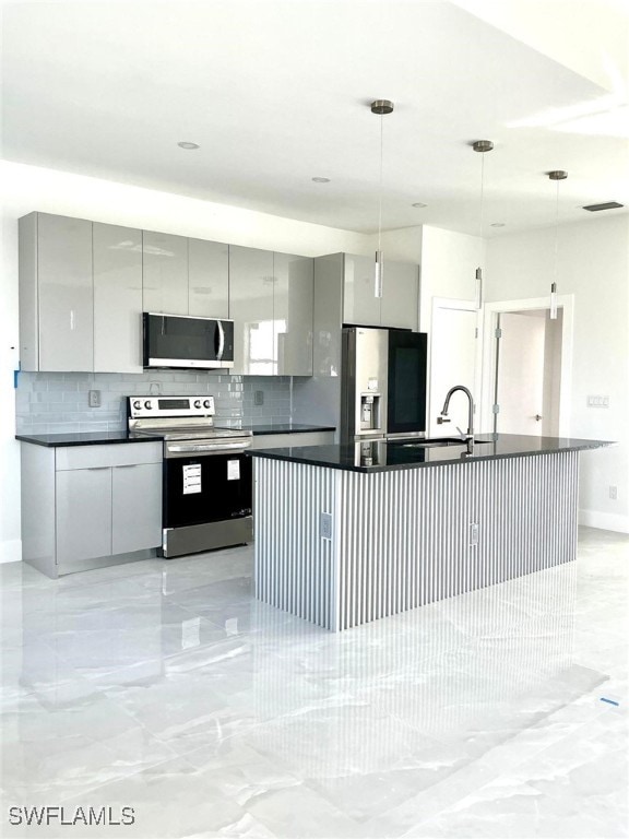 kitchen with appliances with stainless steel finishes, pendant lighting, gray cabinets, and modern cabinets