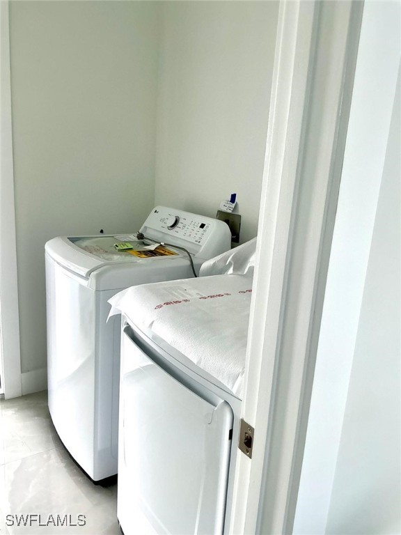 clothes washing area with washer and dryer and laundry area