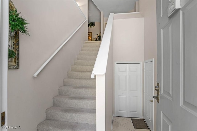 stairs featuring tile patterned flooring