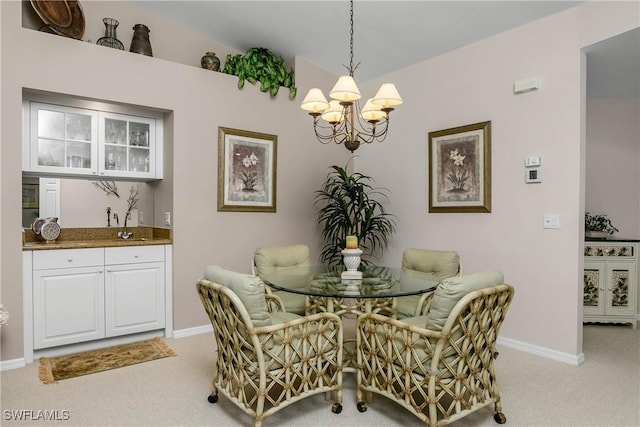 dining area with light carpet, a chandelier, and baseboards