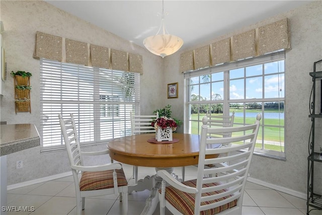 dining room with baseboards and light tile patterned floors