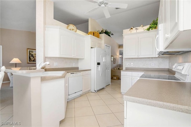 kitchen with a peninsula, white appliances, and white cabinets