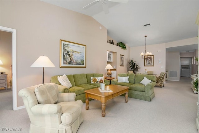 living area with ceiling fan with notable chandelier, baseboards, visible vents, and light colored carpet