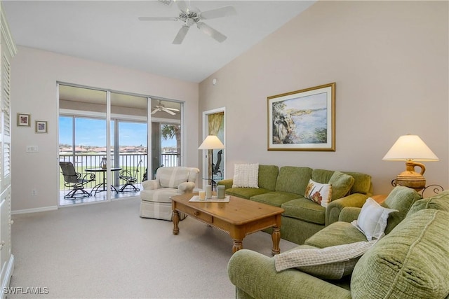 living area with a ceiling fan, carpet flooring, high vaulted ceiling, and baseboards