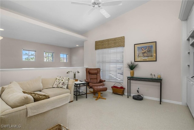 carpeted living area with vaulted ceiling, ceiling fan, and baseboards