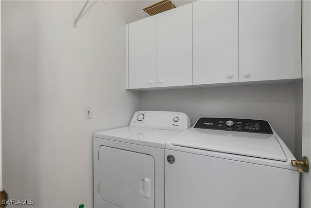 laundry room with cabinet space and washing machine and clothes dryer