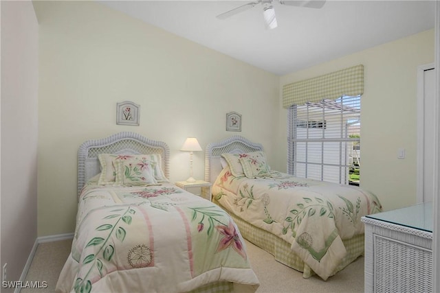 carpeted bedroom featuring a ceiling fan and baseboards