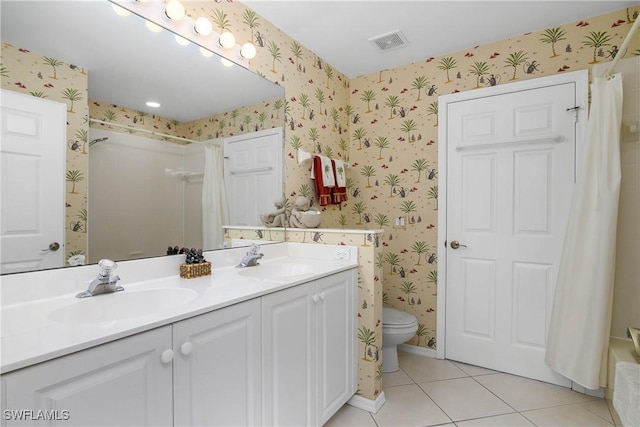 bathroom with wallpapered walls, tile patterned flooring, visible vents, and a sink