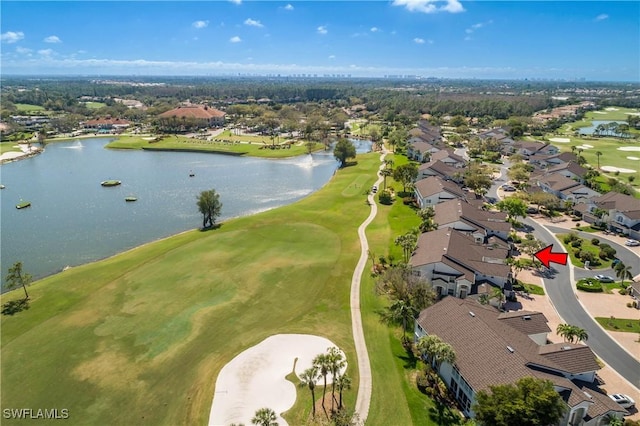 aerial view featuring view of golf course, a water view, and a residential view