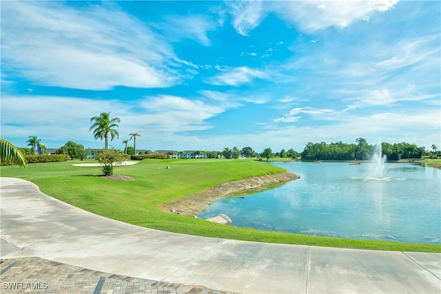 view of community with a yard and a water view