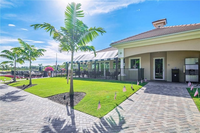 view of home's community with a lawn and fence