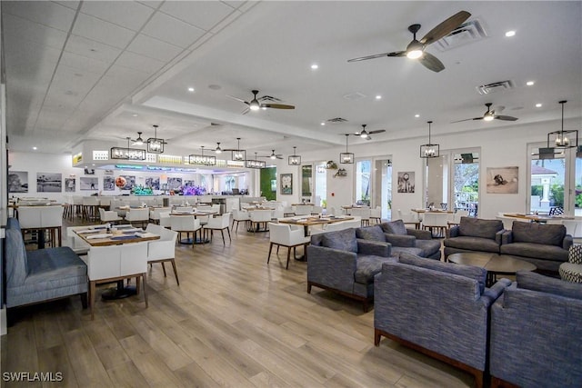 living area featuring a notable chandelier, visible vents, wood finished floors, and recessed lighting