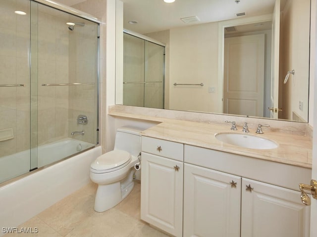 full bathroom featuring bath / shower combo with glass door, vanity, toilet, and tile patterned floors