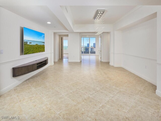 unfurnished living room with ornamental molding and baseboards