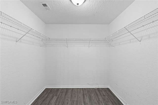 spacious closet with visible vents and wood finished floors