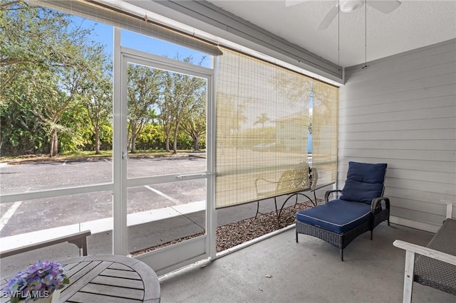 sunroom featuring ceiling fan