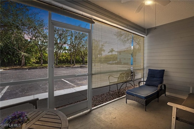 sunroom featuring ceiling fan