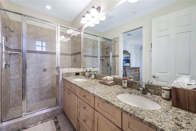 full bathroom with a stall shower, tile patterned flooring, a sink, and double vanity