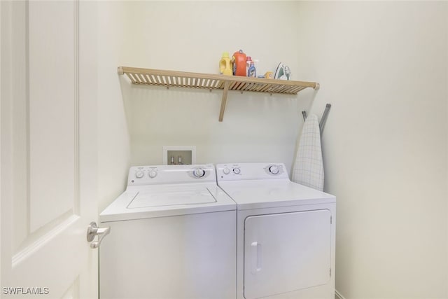 clothes washing area featuring laundry area and washer and clothes dryer