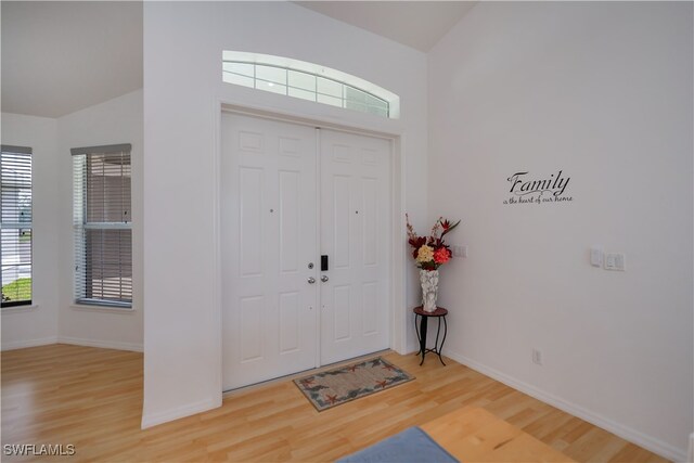 entryway featuring baseboards and light wood-style floors