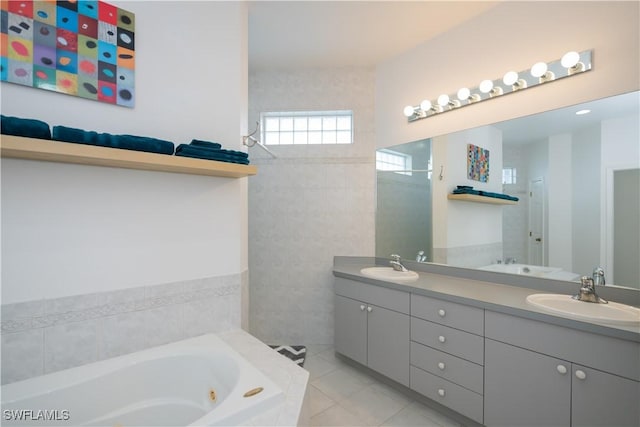 bathroom featuring double vanity, a sink, a jetted tub, and tile patterned floors