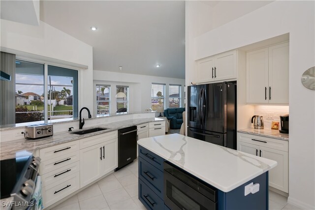 kitchen with white cabinets, a sink, backsplash, and black appliances