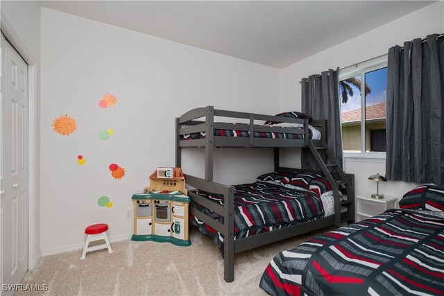 bedroom featuring carpet and baseboards