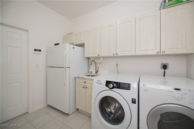 laundry area with washer and dryer, light tile patterned flooring, and a sink