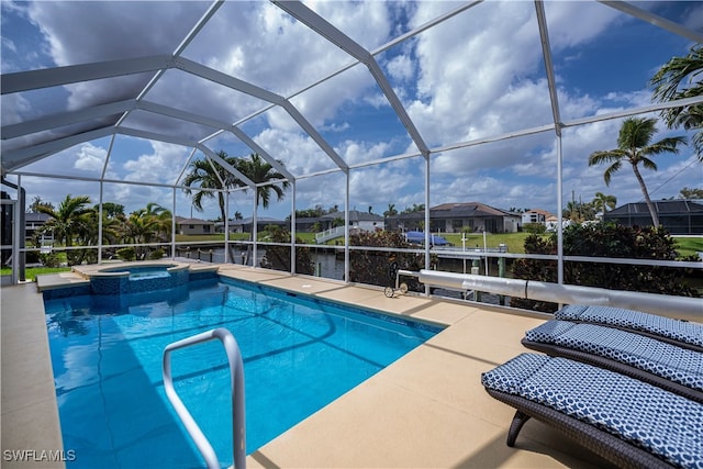 view of swimming pool with a patio area, a pool with connected hot tub, a residential view, and glass enclosure