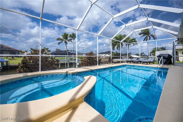 pool with glass enclosure and a grill