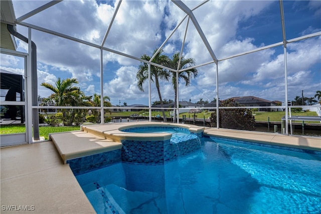 view of swimming pool with a dock, a lanai, a patio area, and a pool with connected hot tub