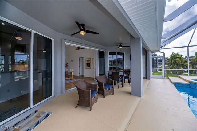 view of patio / terrace with a ceiling fan, a lanai, and an outdoor pool