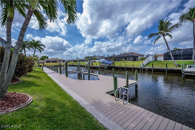 dock area with a residential view, a water view, a lawn, and boat lift