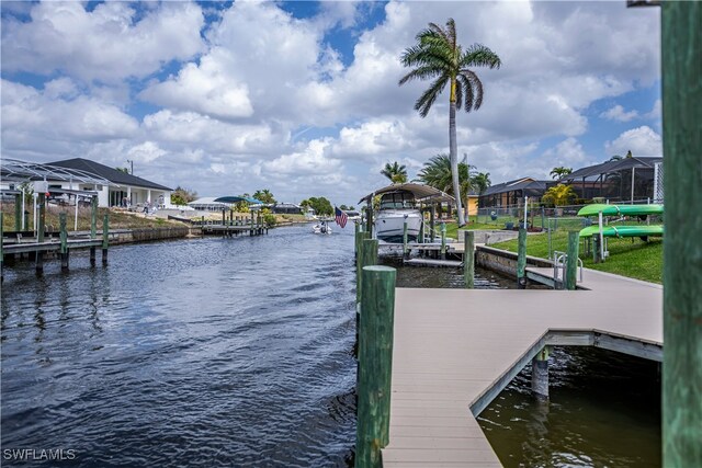 view of dock featuring a water view and a residential view