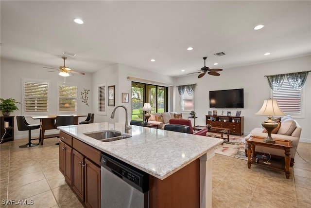 kitchen with a kitchen island with sink, a sink, visible vents, open floor plan, and dishwasher