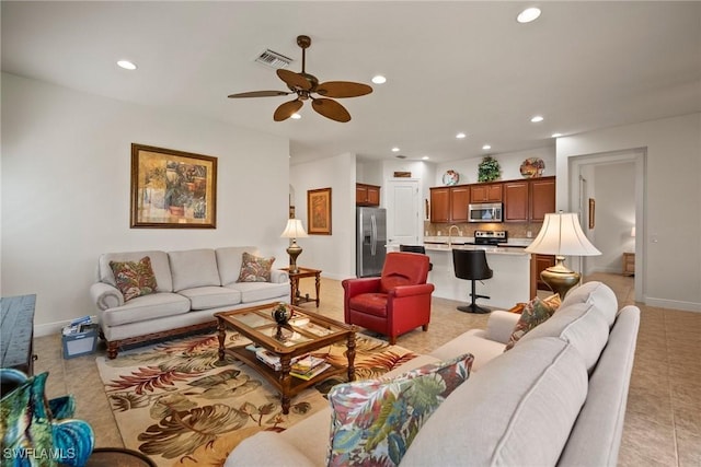 living room featuring light tile patterned floors, recessed lighting, visible vents, a ceiling fan, and baseboards