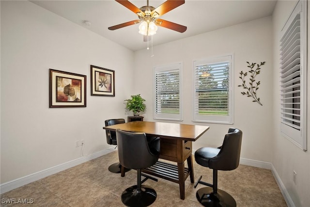 dining room featuring a ceiling fan and baseboards