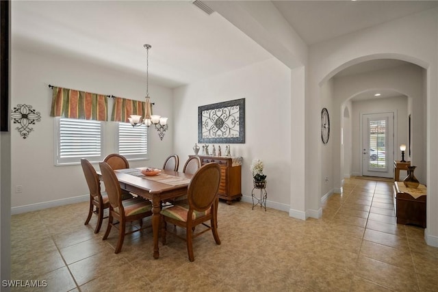 dining room featuring a healthy amount of sunlight, baseboards, and visible vents