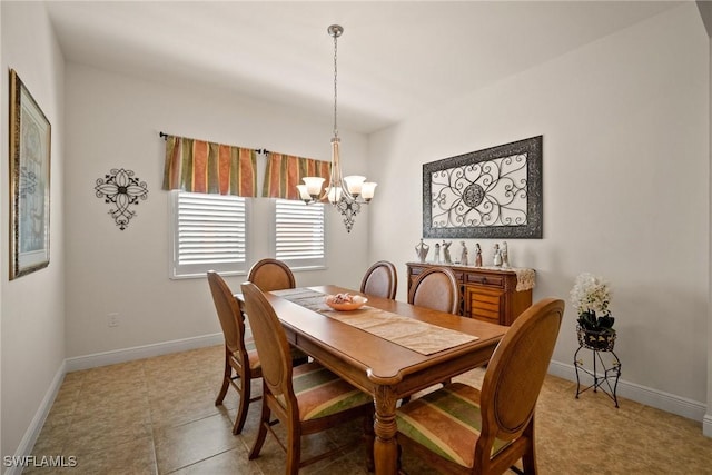 dining area featuring baseboards and a notable chandelier