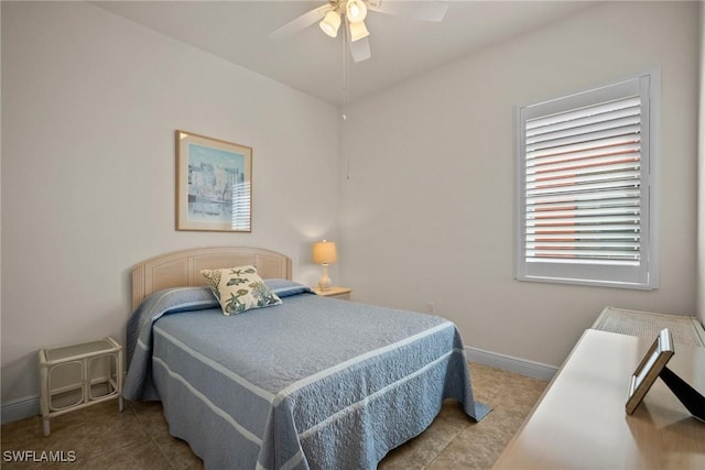 bedroom with ceiling fan and baseboards