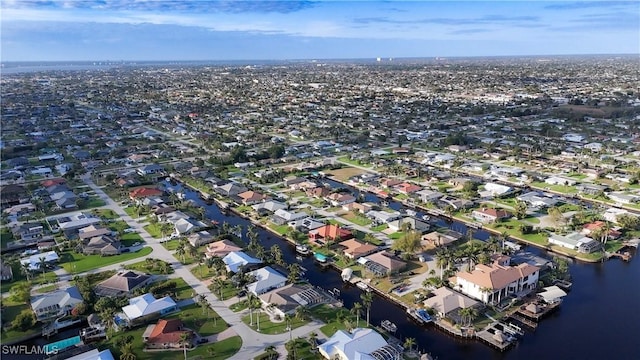 birds eye view of property with a water view and a residential view